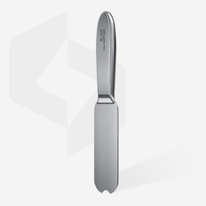 Stainless steel butter spreader standing upright with a broad flat blade and rounded tip against a pale background.