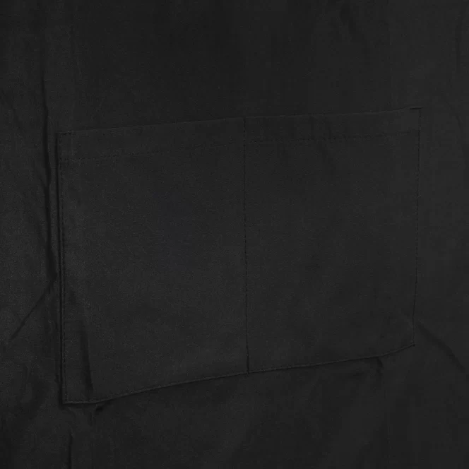 Close-up of black fabric with a stitched rectangular pocket visible on the surface