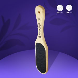 Wooden-handled foot file with a black abrasive pad for pedicures, dual-grit 100 and 180 shown in the corner on a purple background.