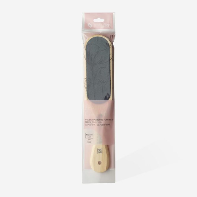 Wooden pedicure foot file in transparent packaging with a pink label; used to remove rough skin from feet.