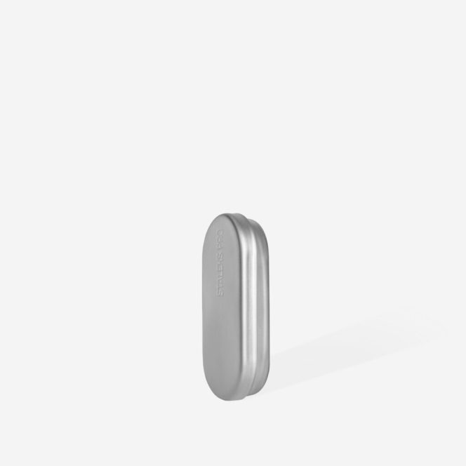 Small silver pill-shaped metal case standing upright on a white background.