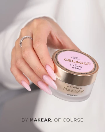Close-up of a hand with long pink nails holding a jar of MAKEAR Gel&Go Builder Gel, pink lid with branding visible.