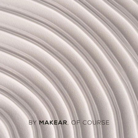 Close-up of pale gray concentric circular ridges; branding text at the bottom reads 'BY MAKEAR, OF COURSE'